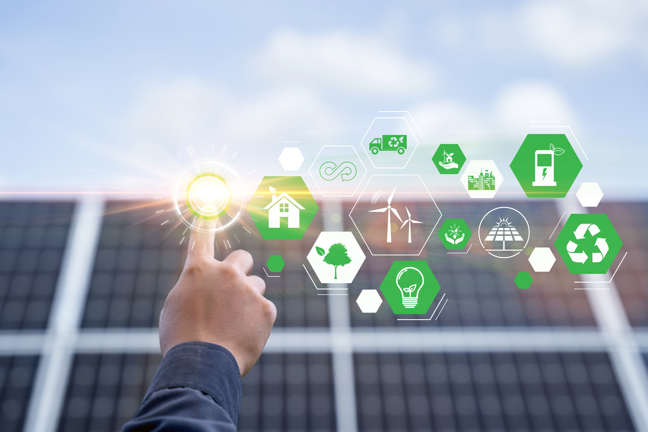 Hand with an icon of energy in front show symbols of various energies with a solar cell in the background, Concepts of clean energy source for renewable. power from the environment to save the world stock photo