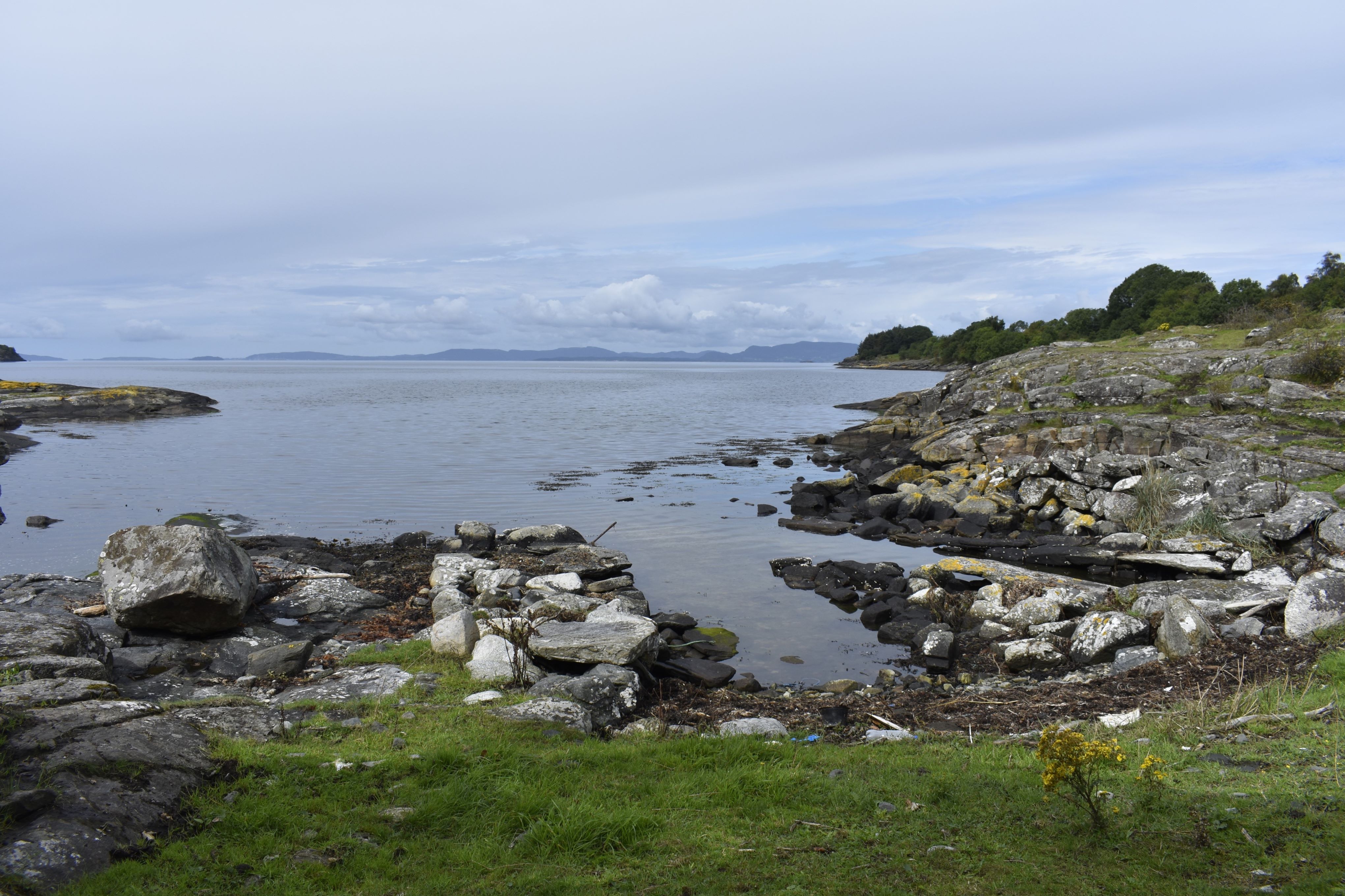 A photo showing cleared lines for pulling up boats to shore, with plastic debris in the foreground