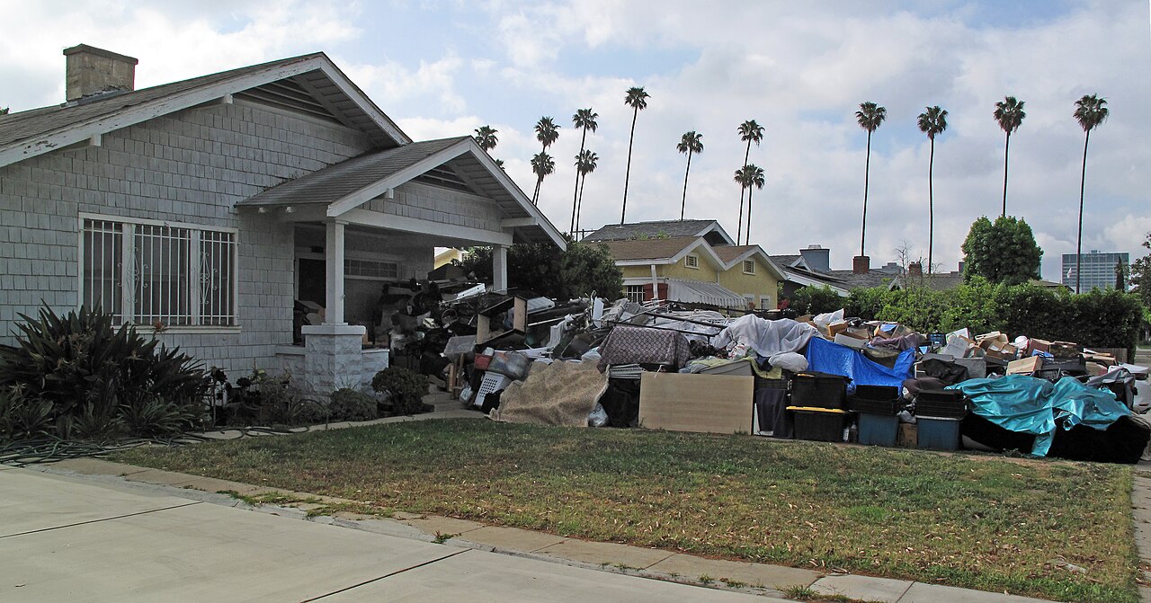 A hoarded house, with the hoard spilling out onto the lawn.