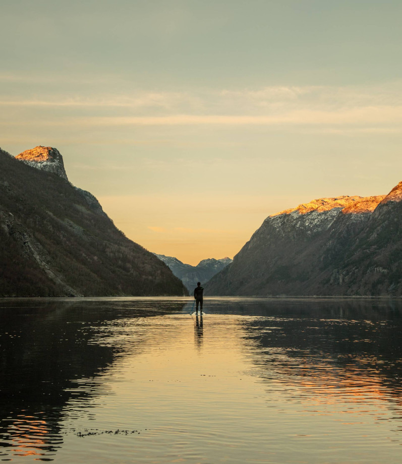 Person på sup-brett i en fjord 