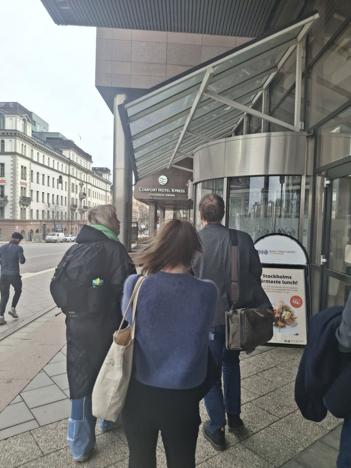 A group of people approaching a conference hall door