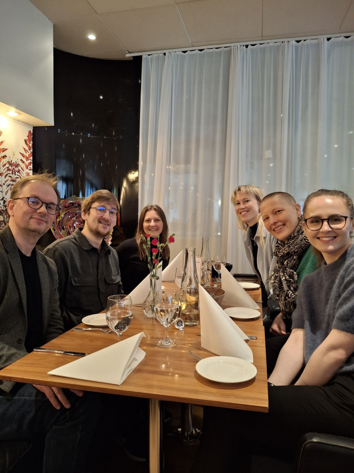 A group of people seated on either side of a dining table